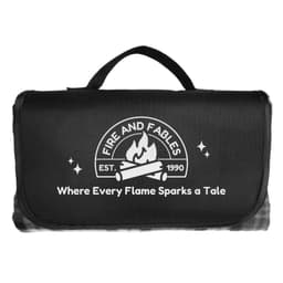 A black picnic blanket with a handle and a logo featuring flames and text.