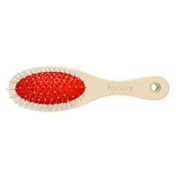 A wooden pet brush with a red rubber grip and metal bristles, featuring a branding logo.