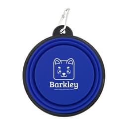 A blue collapsible pet bowl with a black rim and a logo featuring a cartoon dog face, attached to a metal carabiner.