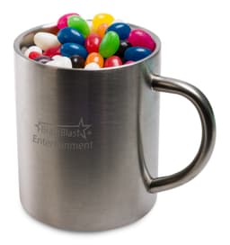 A stainless steel mug filled with assorted colourful mini jelly beans in various shapes. The mug has a logo.