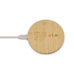 A round bamboo wireless charger with a white charging cable connected. It features a minimal design and has a logo.