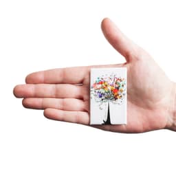 A hand holds a rectangular badge featuring a colourful tree design on a white background. The badge is 45mm x 70mm.