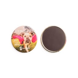 A round magnet featuring a printed image of a dog, with a plain dark back. The magnet has a shiny finish.