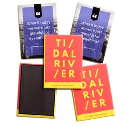 A set of vibrant printed magnets featuring a red design with yellow text, along with a background of blue and black magnets.