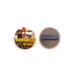 A round, 57mm custom printed magnet badge displaying a colourful design on one side and a magnetic fastener on the reverse.