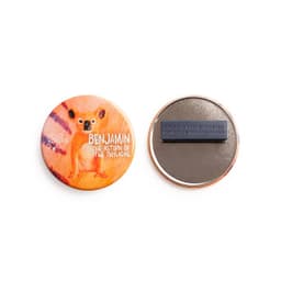 A round 64mm magnet fastener badge featuring an illustrated design and a magnetic backing. Includes a logo.