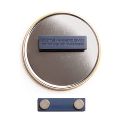 A round, silver magnet fastener badge with a blue backing and two small circular magnets.