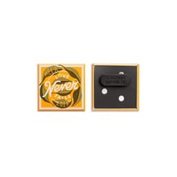 A square magnetic badge featuring a vibrant orange and black design with a caution label on the back.