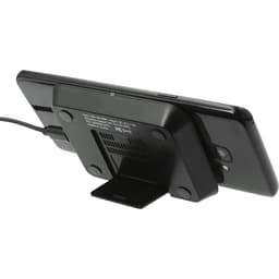 A black wireless charging phone stand with a phone resting against it, featuring a logo on the base.