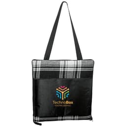 A large picnic rug in black and white plaid, featuring a logo on the front and a carrying strap.