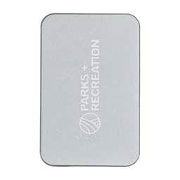 A silver power bank with a minimalist design and a logo. It features rounded corners and a sleek finish.