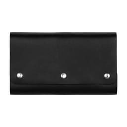 A black leather travel card set with three metal studs, featuring a sleek, folded design.