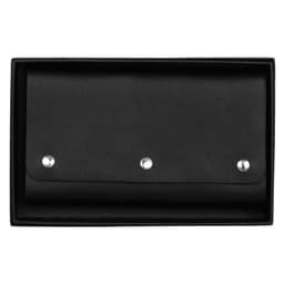 A black leather travel card set with a snap closure, presented in a matching box. It features decorative metal snaps.