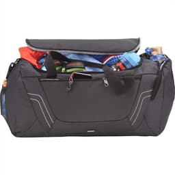 A black duffel bag with multiple compartments, packed with various items including clothing and a drink bottle.