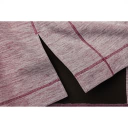 A close-up of a maroon and grey knitted half zip jumper, featuring side slits and contrasting stitching.