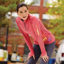 A red knit quarter zip jumper for women featuring long sleeves and a logo. Suitable for casual wear or exercise.