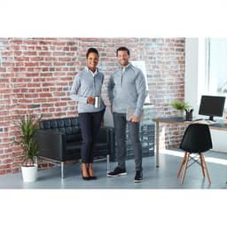 A grey knitted half zip jumper worn by two models, one holding a drink, posed in a modern office setting.