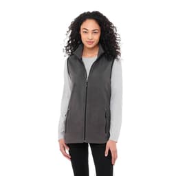 A women's polyfleece vest in grey, featuring a zip front and pockets, worn over a long-sleeve top.