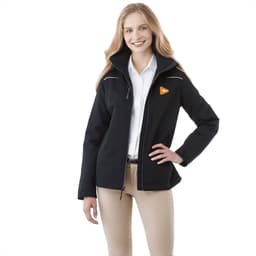 A woman wearing a black fleece lined jacket with a logo, styled with cream pants and a white shirt.