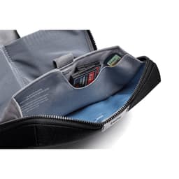 A black tech kit featuring a zippered compartment, blue lining, and pockets for organising small items and cards.