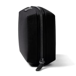A black tech kit with a structured shape and a zipper closure, featuring one logo on the side.