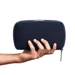A hand holding a dark navy tech kit with a zippered closure, featuring a minimalist design and branding.