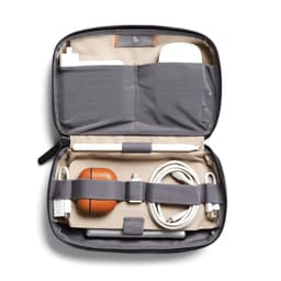 A grey tech kit containing charging cables, an Apple Pencil, and a brown AirPods case, with an interior pocket.