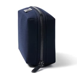 A navy blue rectangular tech kit with a sturdy zipper and branding on one side.