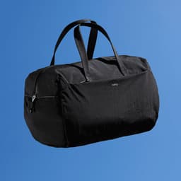 A black duffle bag with two handles and a branded logo, set against a blue background.