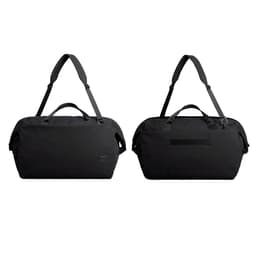 A black duffel bag with dual handles and an adjustable shoulder strap, featuring a logo on the side.
