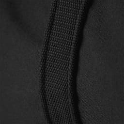 Close-up of a black duffel bag featuring textured fabric and sturdy stitching along the strap.