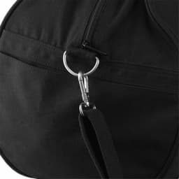 A close-up of a black duffel bag featuring a zipper and metallic clip detail, showcasing its sturdy canvas material.