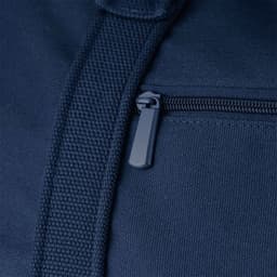 A close-up of a navy blue duffel bag featuring a zippered pocket and textured fabric. It has a logo present.