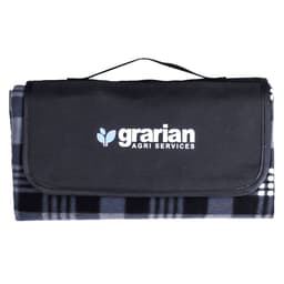 A picnic blanket in grey and black, folded with a carrying handle and a logo on the front.