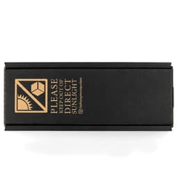 A black box with a logo, featuring instructions to keep out of direct sunlight.