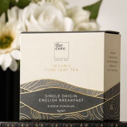 A box of organic pure leaf tea with a white and gold design, containing eight brew pyramids. It has a logo on the front.