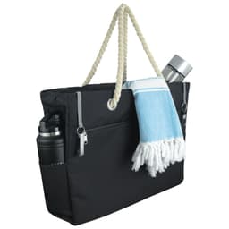 A black waterproof beach bag with a rope handle, featuring a drink bottle, a towel, and side pockets.