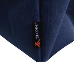 A close-up of a navy blue waterproof beach bag, featuring a small branded tab.