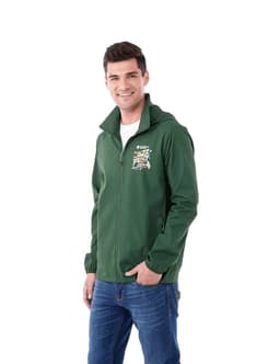 A man is wearing a green packable jacket with a hood and a logo on the front. The jacket is styled for rain protection.