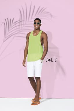 A unisex singlet tank top in bright green, worn by a model in white shorts and sunglasses, with a logo present.