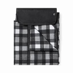 A foldable black and white checked blanket with a black flap, featuring a logo on the corner.
