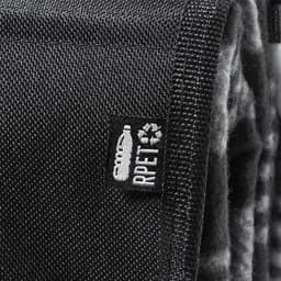A textured black fabric with a small tag, featuring a logo and branding details.
