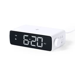 A digital alarm clock in white with a large black display showing the time 6:20 and a control knob on the side.