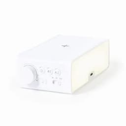 A white audio device with a large dial and control buttons, featuring a USB port on the side.