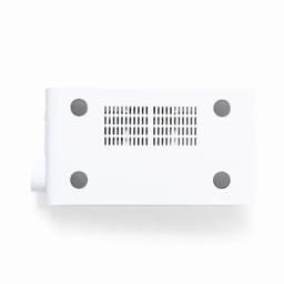 A white rectangular device with ventilation holes and four circular feet on the bottom.