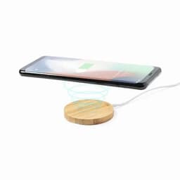 A wireless charging pad with a bamboo surface and a smartphone hovering above it, indicating charging in progress.
