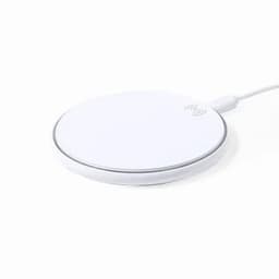A wireless charger in a circular design, featuring a white surface with a thin silver edge.