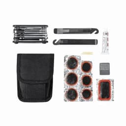 A multi-tool kit featuring several tools, adhesive patches, and a black carrying pouch.