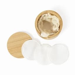 A bamboo container with a lid, featuring reusable cotton pads inside. Three white pads are visible next to the container.