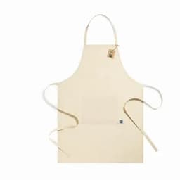 A cream-coloured apron featuring long ties and a front pocket, with a small logo tag attached.